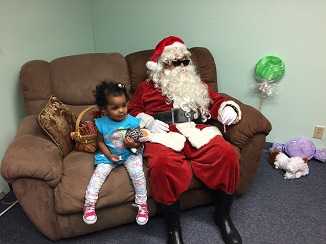 Blind Santa posing with a little girl